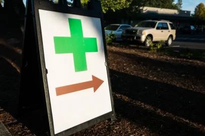 Marijuana dispensary sign with red arrow; buy weed in Miami