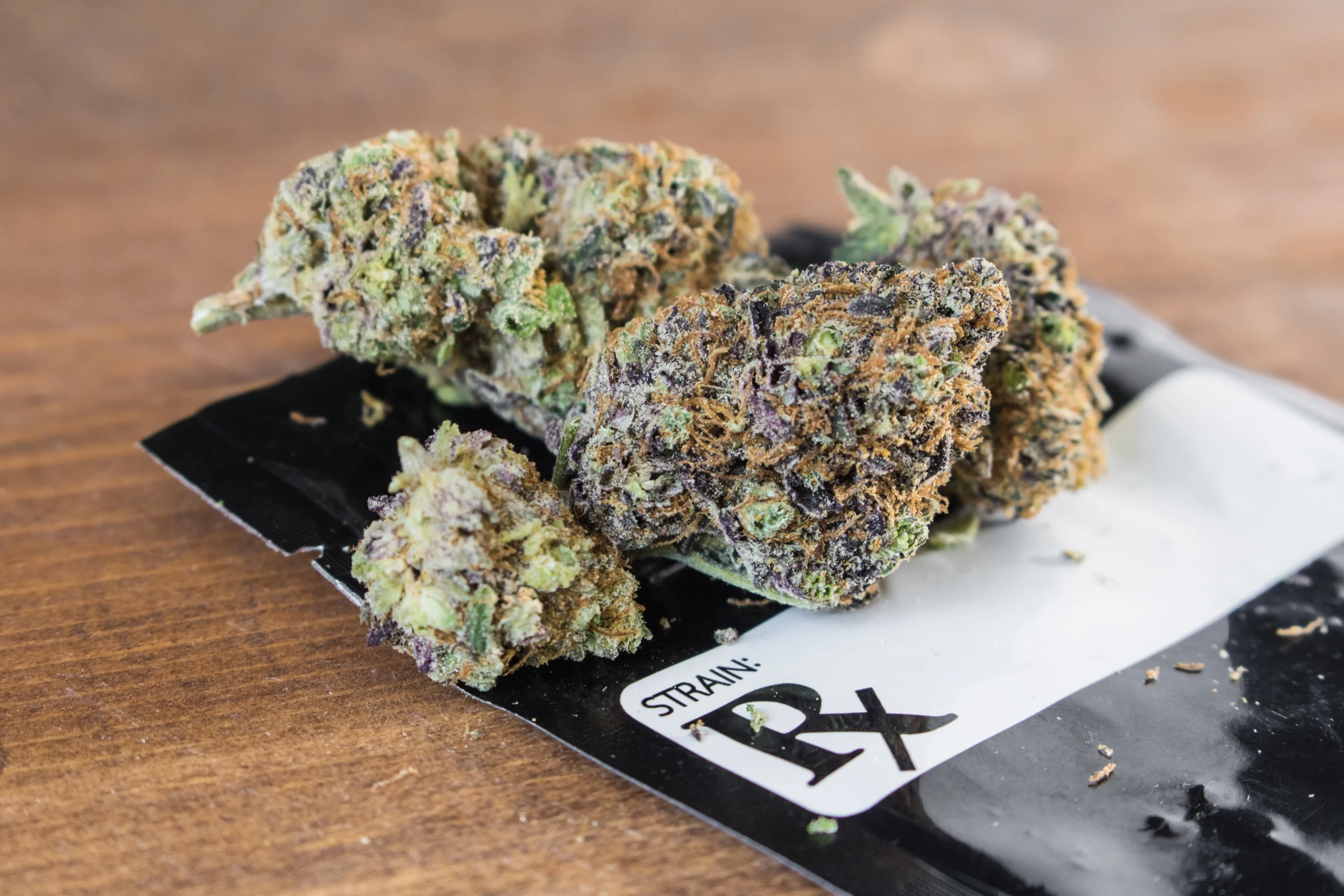 Grape Ape strain on top of medical cannabis pouch